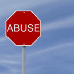 Stop sign with the word abuse on it