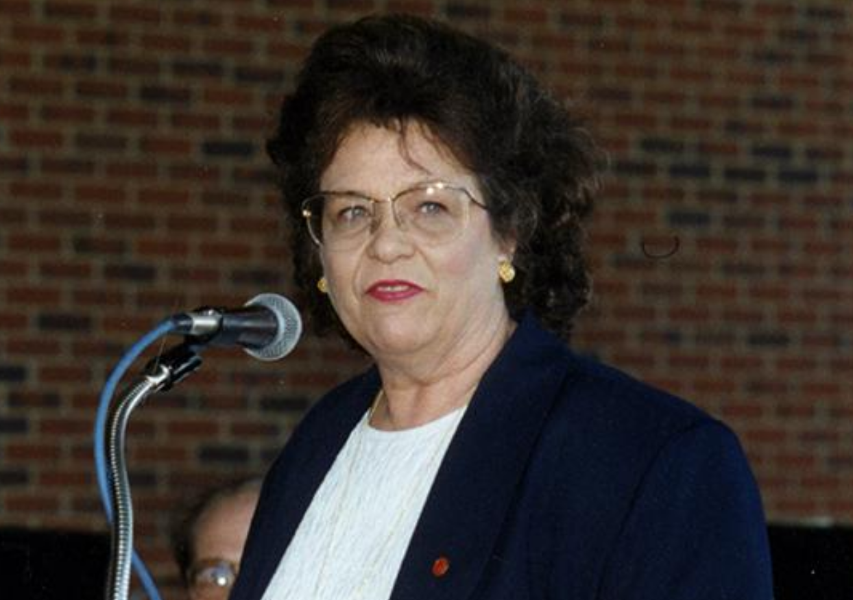 Barbara Burch speaking into a microphone