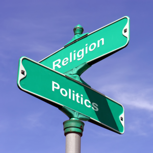 Intersection road signwith "religion" and "politics" written instead of street names.