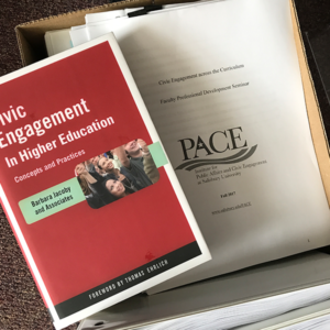 A box of papers and a booklet about civic engagement.